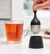Placing the tea infuser in its base after use