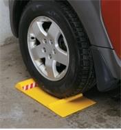 Car wheel positioned on a parking mat