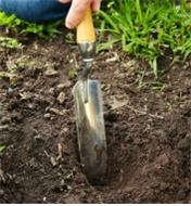Digging in garden soil using the Lee Valley Narrow Trowel
