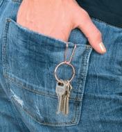 SqueezeRing Key Clip attached to a back pocket, with keys dangling