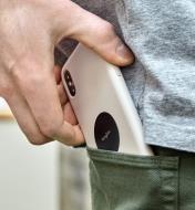 Slipping a cell phone with a steel disc attached to its case into a pants pocket