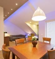 A dining room/living room lit with LED down lights