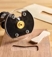 Using an inlay bushing and rotary tool to cut the recess for a bowtie wood joint