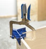 A Kreg corner clamp holds a 90° corner of a cabinet
