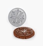 Snowflake stamp next to a cookie with the design stamped on it