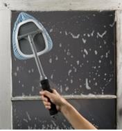 Using the Glass and Surface Cleaner to wash a window