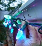 Hooking Christmas lights onto an eavestrough