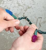 Winding a Christmas lights wire into the corkscrew portion of a hanger