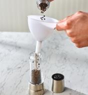 Using a funnel to refill a Cole & Mason pepper mill through its removable top