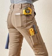 Side view of pants showing the pockets holding various tools
