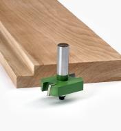Extra-Large Rabbeting bit next to a board with a rabbet cut along the edge