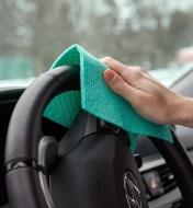 Wiping a car steering wheel using a reusable household paper towel