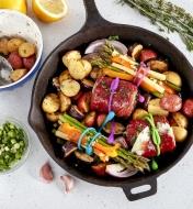 Vegetables and beef roulades secured with FoodLoop in a cast-iron pan before cooking