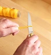 Cutting cord with the Laguiole knife
