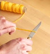 Cutting cord with the Laguiole knife