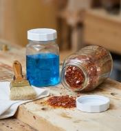 Canning jar lids on jars holding stain and shellac