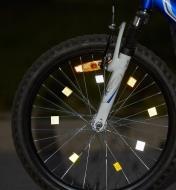 Bicycle wheel with reflective tape applied to the spokes