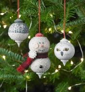 Decorated wooden ornaments hanging on a Christmas tree