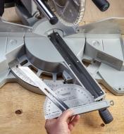 Using with a sliding bevel with the protractor to determine a cut angle for a miter saw