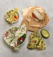 Beeswax wraps used to cover fruit, salad, an avocado and a sandwich