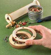 Placing colored peppercorns inside the viewing case of the ever-changeable kaleidoscope