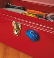 A Mini Utility Knife attached to a toolbox by its integral magnet
