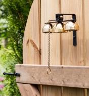 Garden bells mounted on a wooden gate