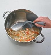 Using the Nylon Ladle to scoop soup from a pot