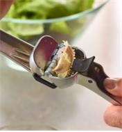 Garlic peels being pushed out of the hopper of the Garject Garlic Press