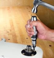 Using the impact driver to loosen a screw on a lathe tailstock