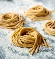 Fresh bigoli noodles made using a Marcato pasta machine with the bigoli cutter attachment