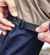 Cinching the adjustable strap on a nylon gaiter