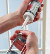 Using the seal puncture tool on a tube of caulk