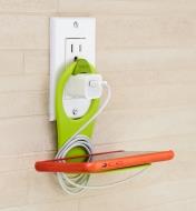 Lime Folding Phone Holder hooked over a charger in an outlet, holding a cell phone