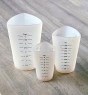 Set of three flexible silicone measuring cups sitting on a counter