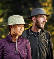 A man and a woman each wearing a classic travel hat