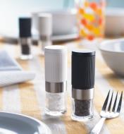 Mini salt and pepper grinders on a dining table