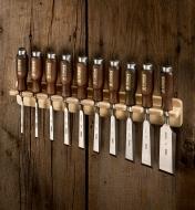 A set of ten Narex bevel-edge chisels held in a wall-mounted rack