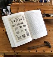Roubo On Furniture, deluxe edition, opened on a workbench, showing an illustration of chair designs