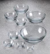 A set of nine Duralex glass bowls arranged on a countertop