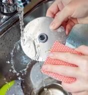 Hand washing the pizza cutter wheel