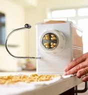 Fresh macaroni noodles being made with the Marcato pasta extruder
