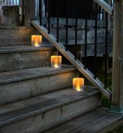 Three Inflatable Solar Candle Lanterns placed on outdoor steps