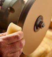 Applying conditioning wax to the grit wheel of the razor sharp kit