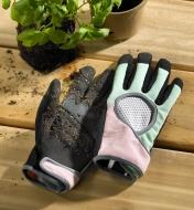 Women’s garden gloves encrusted with soil