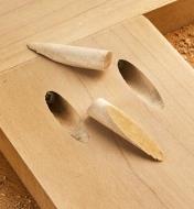 Wooden plugs cut with the Kreg 740 custom plug-cutter kit, ready to be inserted in two pocket holes