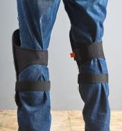 Back view of the large premium knee pads strapped to a person's knees