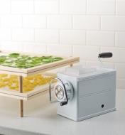 Marcato pasta extruder beside a pair of pasta and herb drying racks