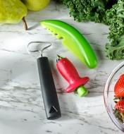The fruit & vegetable corer, the herb stripper and the strawberry huller on a countertop