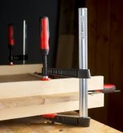 A Bessey 4 1/2" Medium-Duty FA Clamp used to clamp a cabinet panel